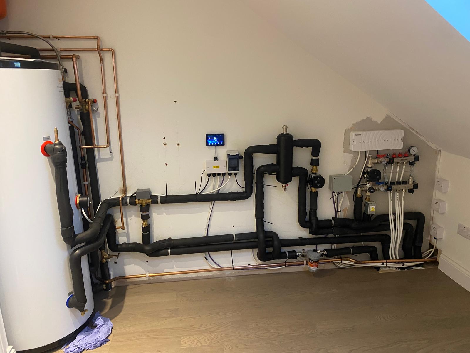 Loft plant room with cylinder and manifolds